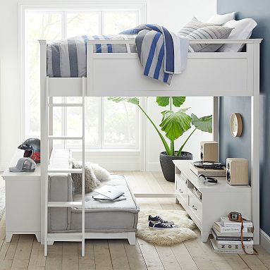 A bedroom with loft bed and white cabinets and grey sofa and wooden floor 