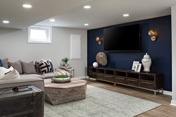 A navy blue living room with grey wall and sofa with cushion