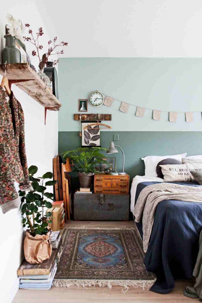 A green wall and light sage green n bedroom and wooden floor 