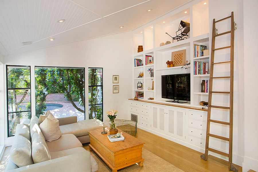 A sunroom with wooden floor and tv in the room 
