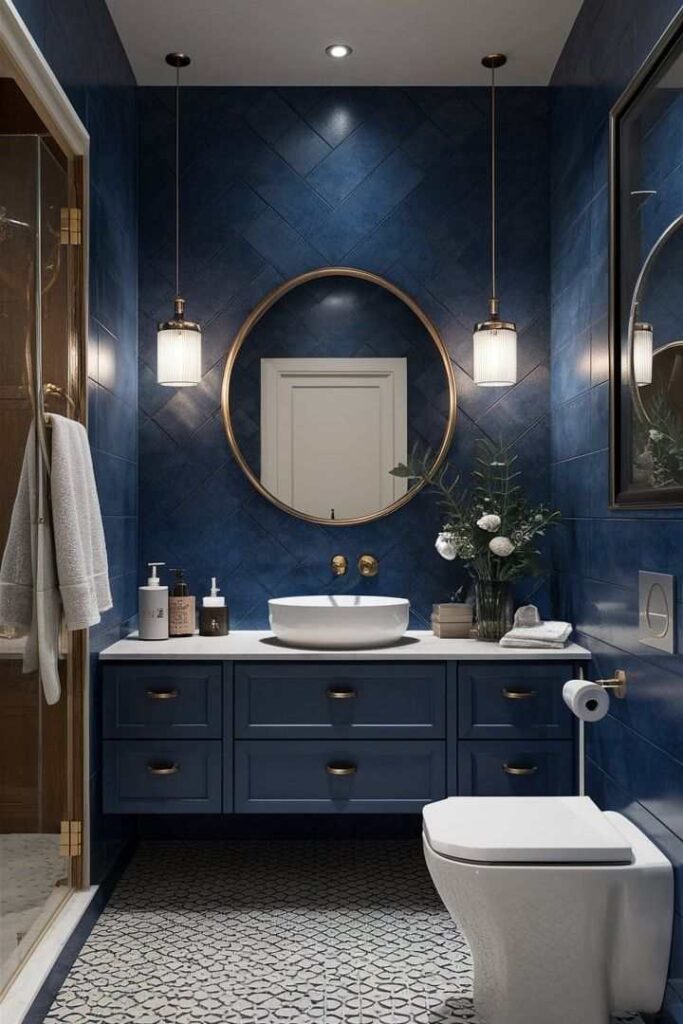 A navy bathroom with lights on the wall and white sink and blue vanity and mirror on the wall 