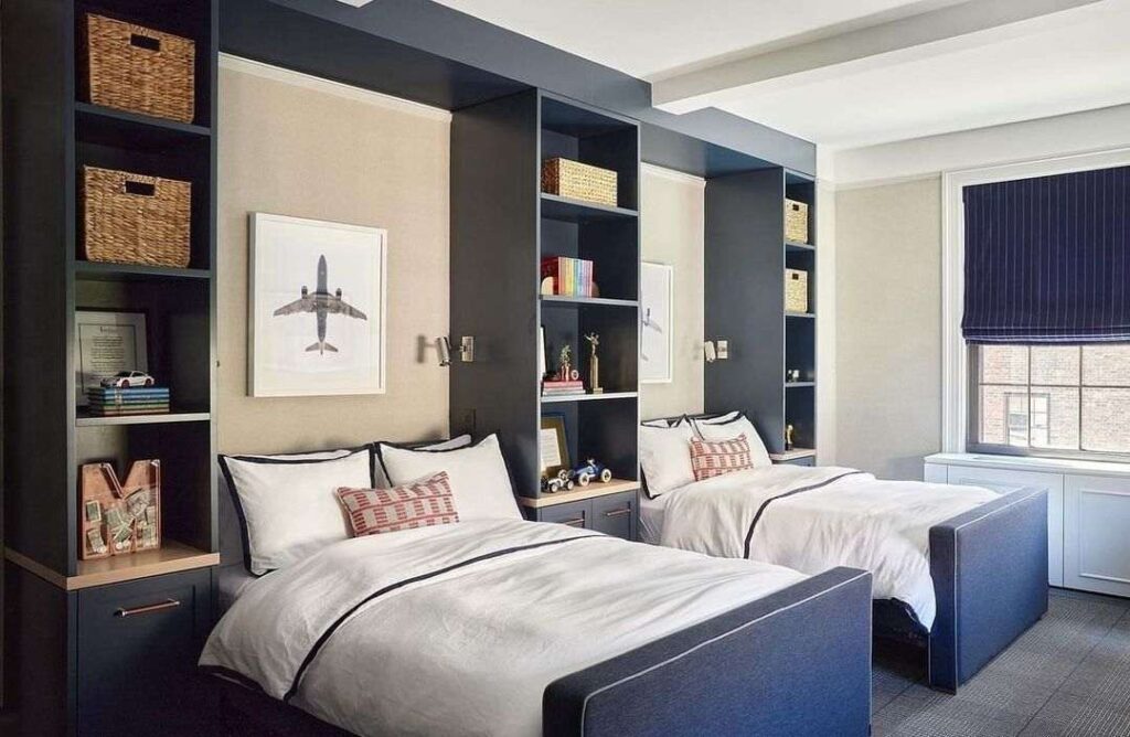 A bedroom with two beds and built-ins storage space 