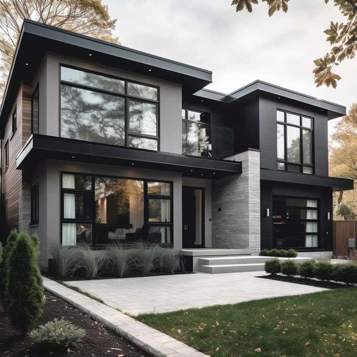 A grey house with dark grey sidling and glass windows with black trim 