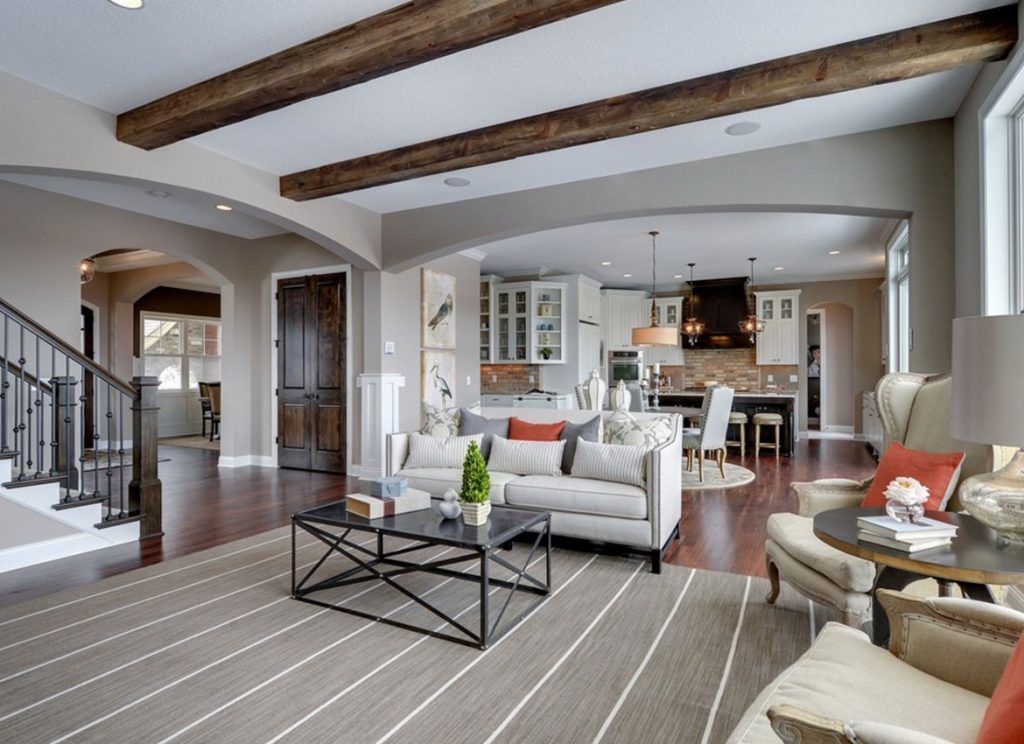 A grey living room with sofa and table and wooden floor 