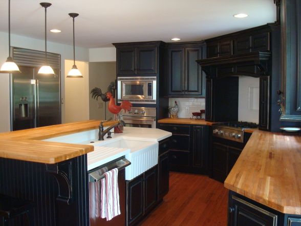 A kitchen with wooden butcher block and wooden floor 