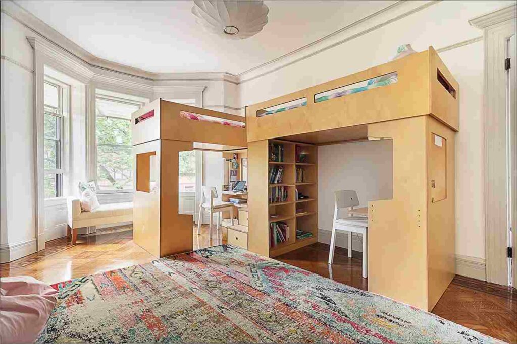 A wooden loft bed with window ad wooden floor and book storage