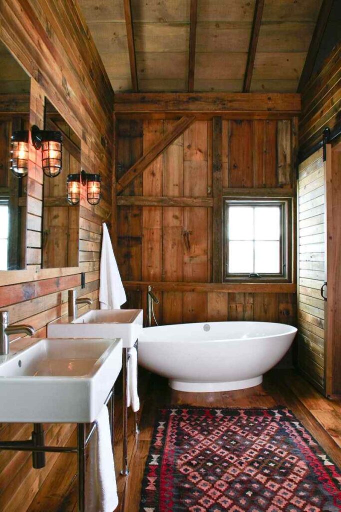 A bathroom with wood panel and white bathtub and window