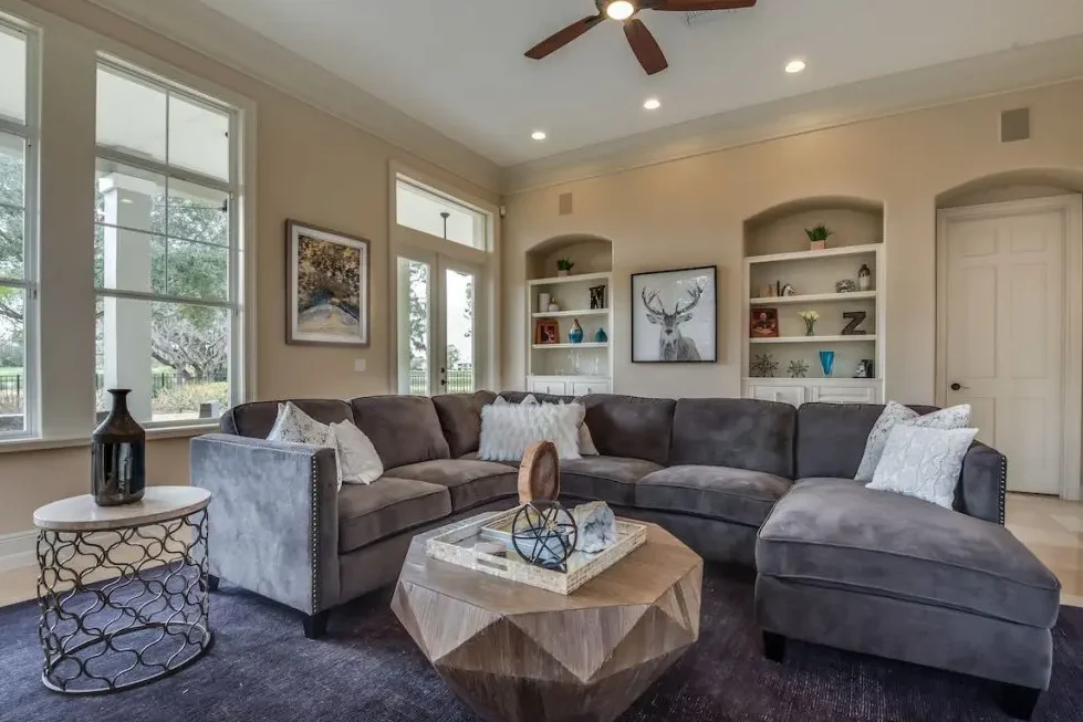 A beige and grey living room with sofa and cushion
