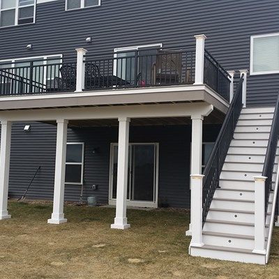 A grey house with black balcony and white trim