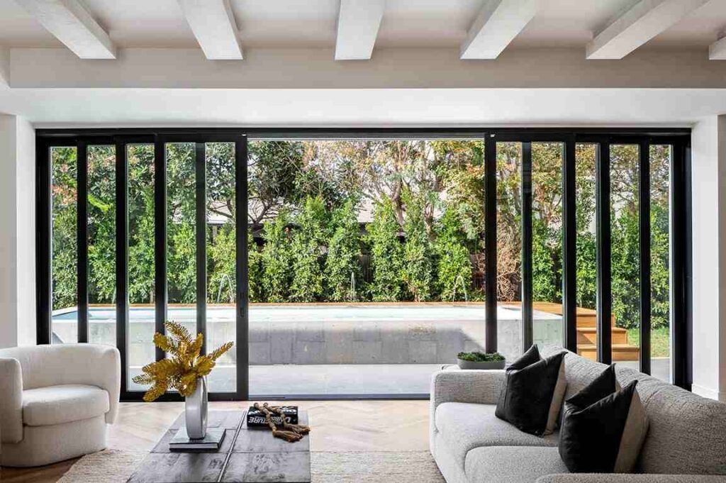 A black framed sliding glass doors in sunroom 