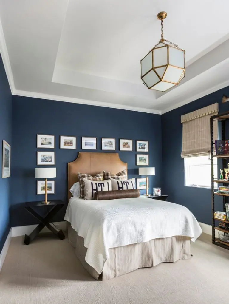 A navy blue bedroom with white celling and wooden floor