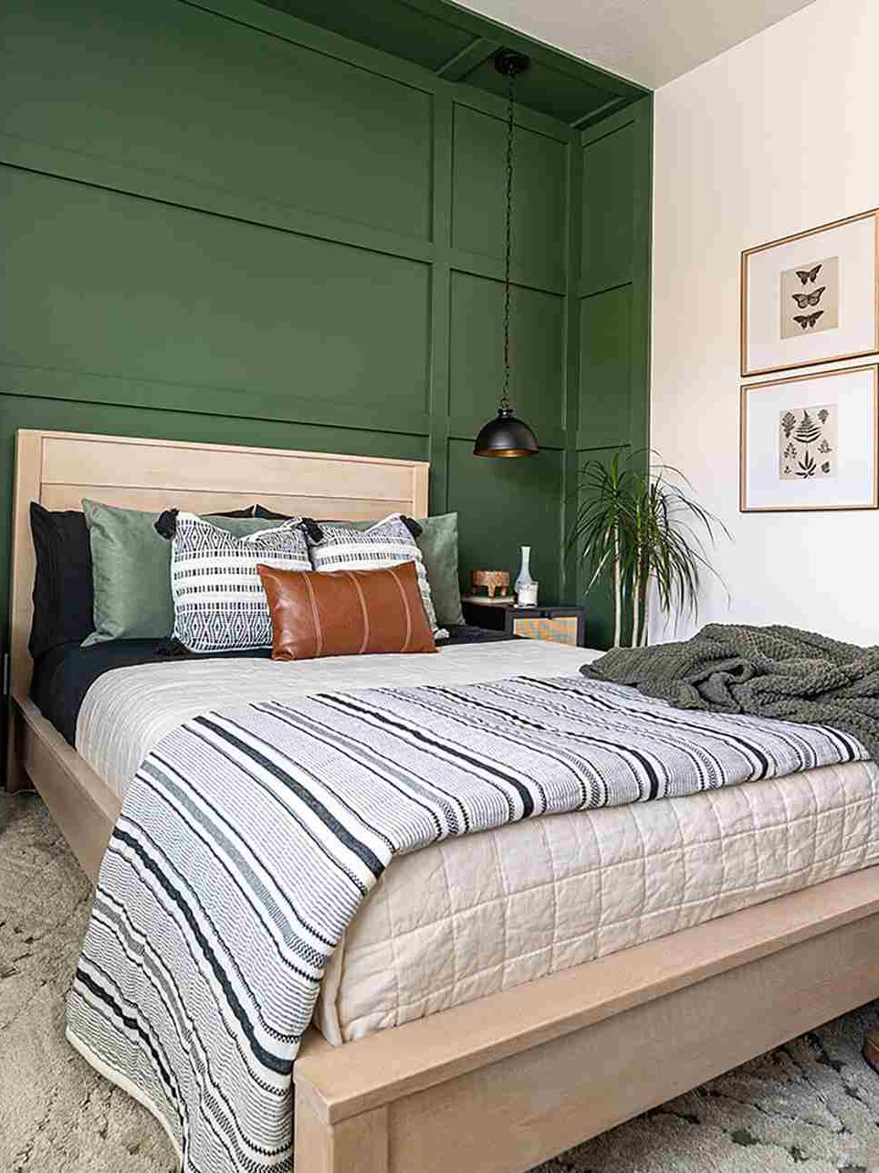 A board and batten bedroom with beige bedding and pillow and blankets 