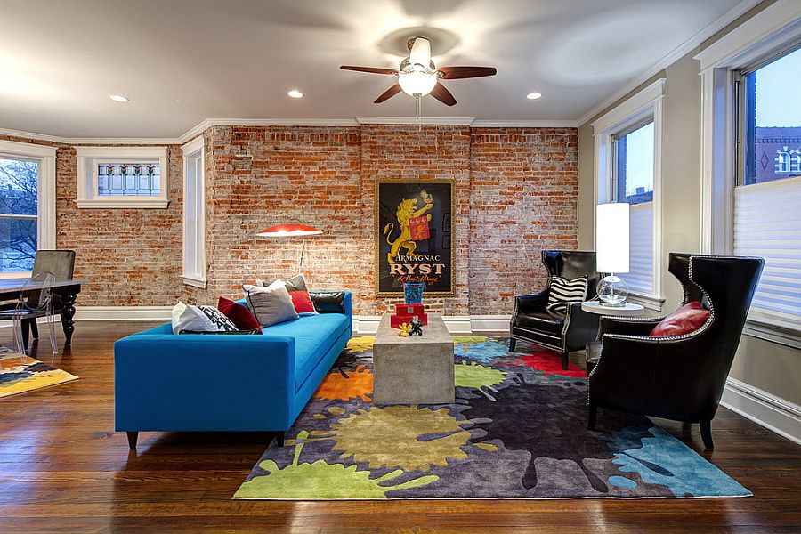 A living room with brick wall and windows and wooden floor 
