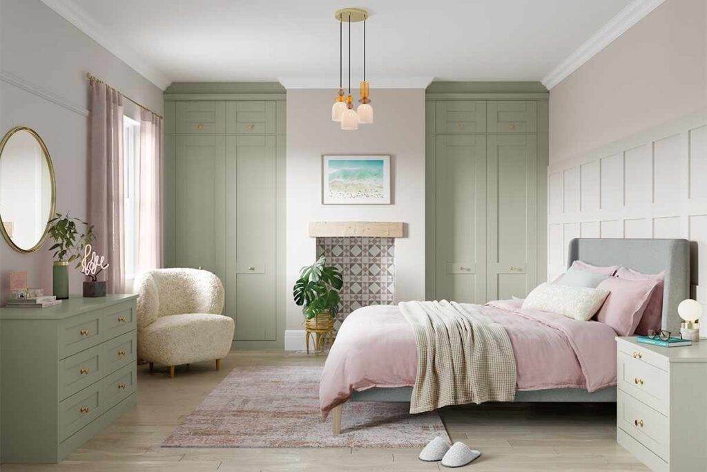 A sage green and beige bedroom with windows and curtains and wooden floor and mirror on the wall
