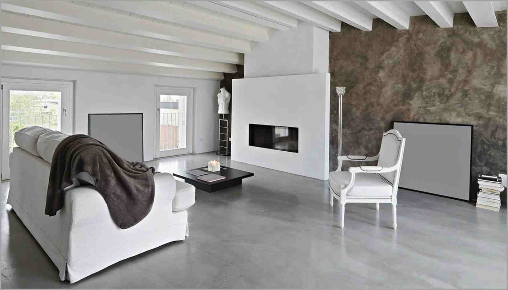 A living room with concrete floor and white beams celling 