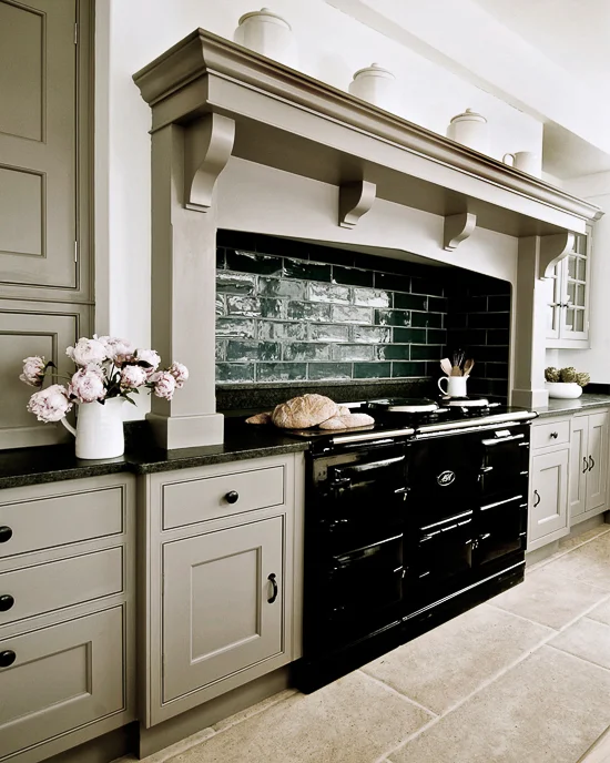 A cream and black kitchen and wooden floor 