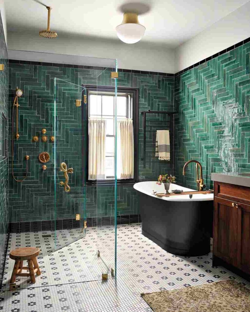 A bathroom with gold shower kit and black bathtub and wooden vanity and windows
