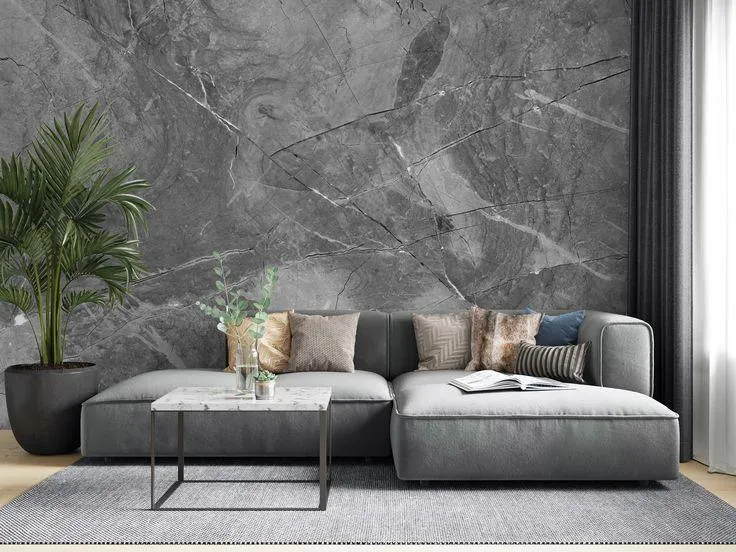 A living room with grey  textured and sofa and wooden floor 