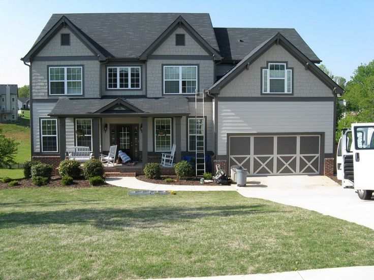 A grey house with black trim and white framed windows