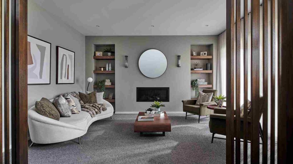 A grey living room with mirror on the wall and beige sofa