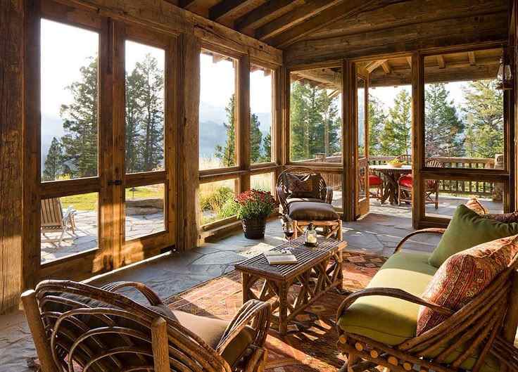 A modern sunroom with wooden chairs and table 