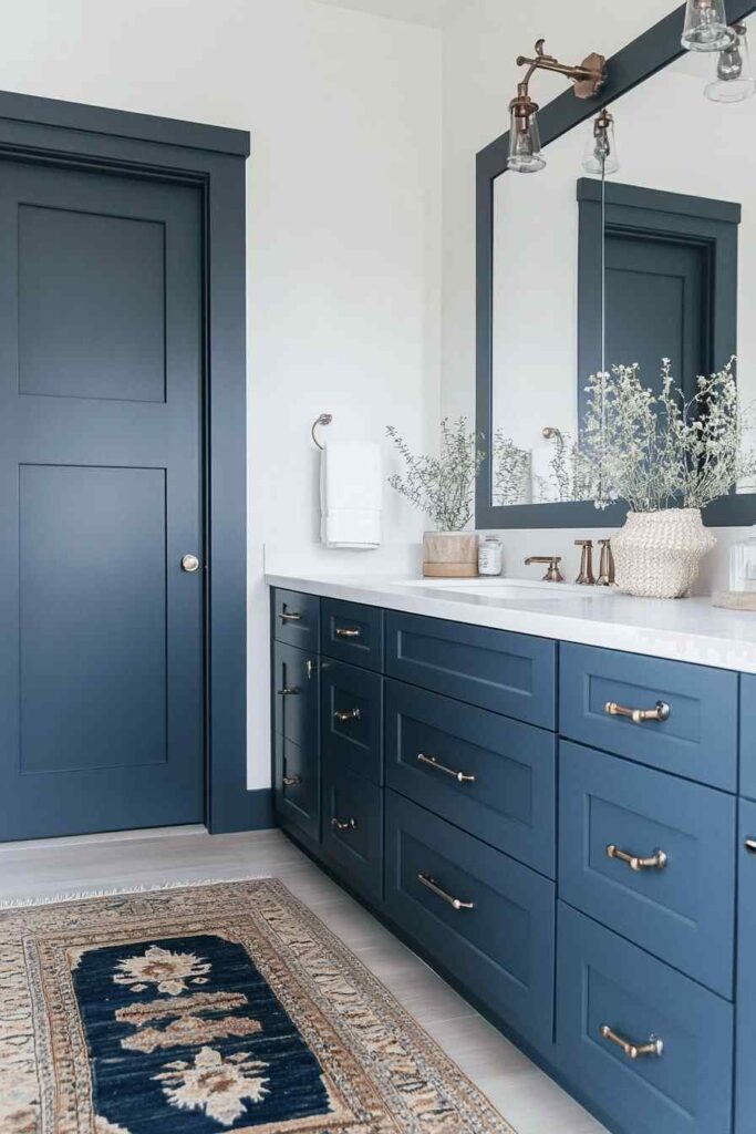 A navy blue bathroom with door and vanity 