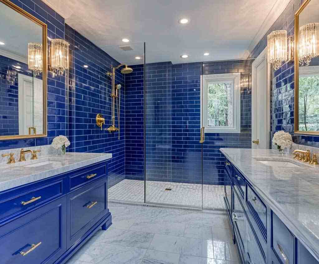 A blue bathroom with tiles and white floor and vanity countertop 