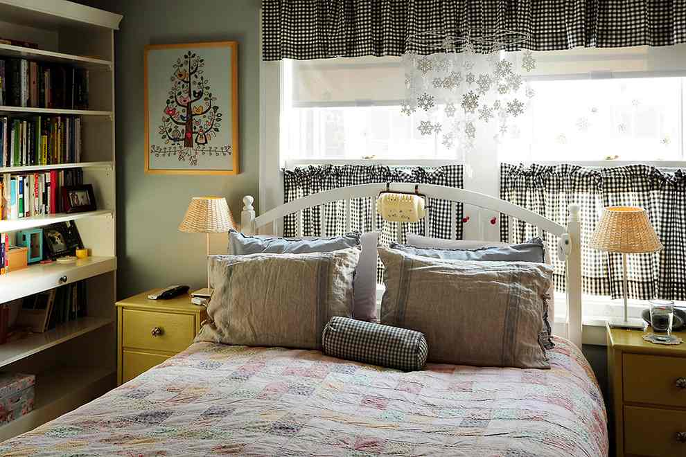 A bedroom with for cafe curtains and bed with pillow and nightstand