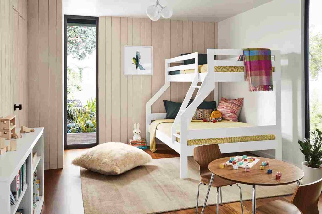 A loft bed and wooden floor and rug on the floor