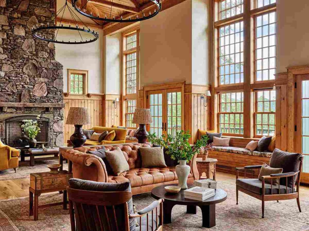 A living room with fireplace and wooden frames windows 
