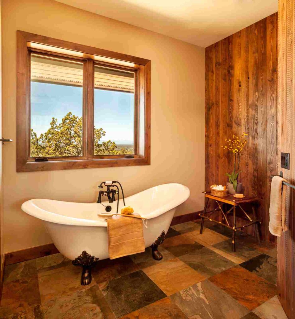 A bathroom with rustic clawfoot tub and wooden floor