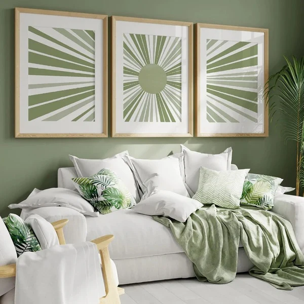 A sage green living room with sage and white artwork on the wall 