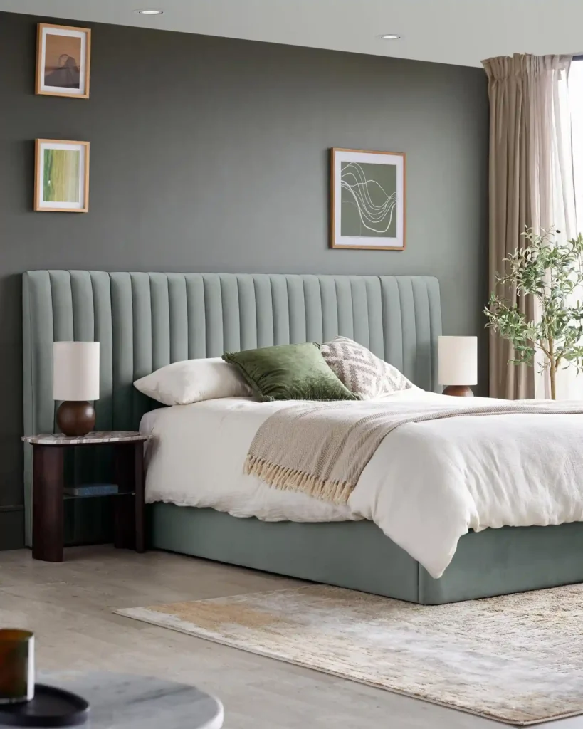A sage bedroom with bedding and white blankets and pillow and cushion 