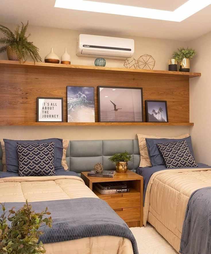 A bedroom with two beds and nightstand with storage 