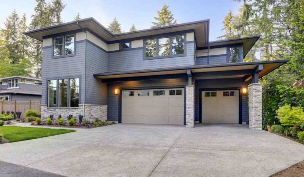 A grey house with black trim and black framed glass windows