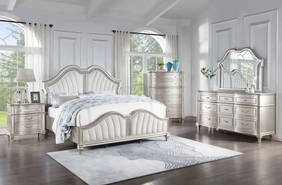 A bedroom with vanity and mirror and white windows and curtain and rug on the wooden floor 