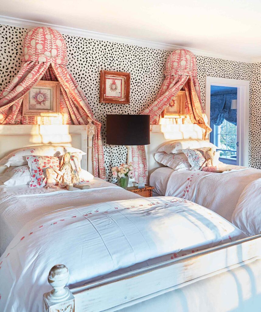 A bedroom with wall canopy and wooden frames on the wall 