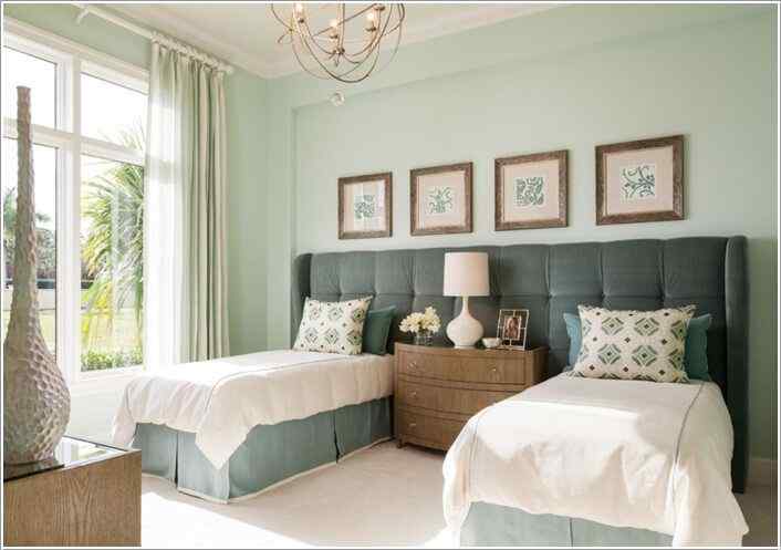 A two beds in a small room with wooden deck and lamp on it