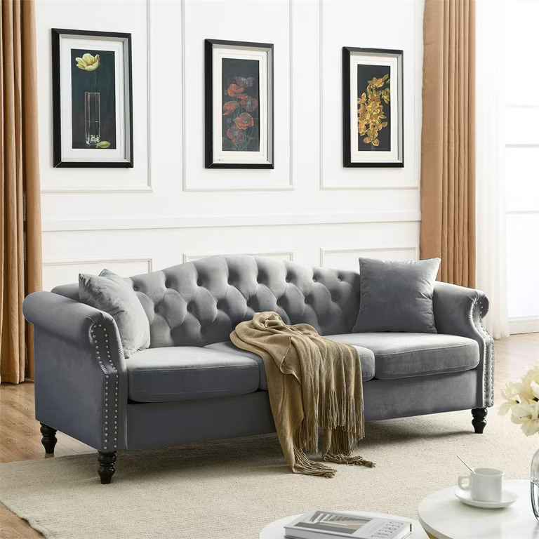 A white panel wall with grey sofa and wooden floor and rug on it
