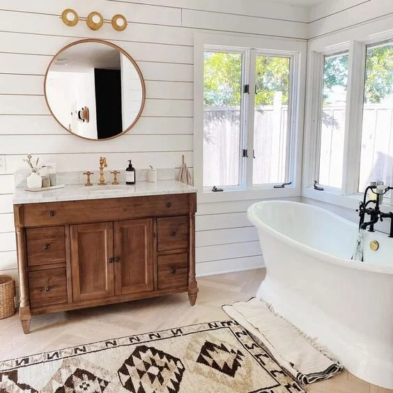 A wooden vanity with mirror on the wall ans wooden floor