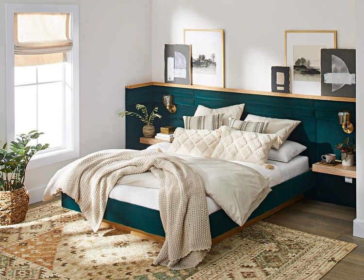 A white bedroom with green bedding and blankets and pillow and cushion